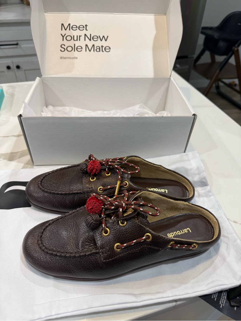 Larroude Dark Brown Leather Mules with Red Tassel Accents